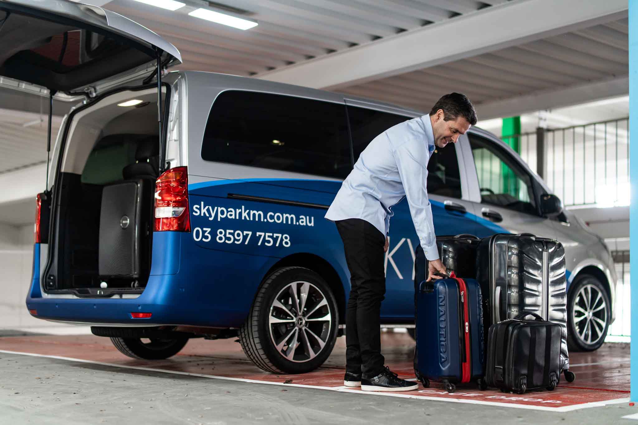 Helpful Staff Unloading Airport Shuttle